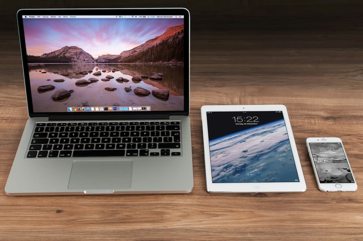 A laptop, tablet and phone side by side