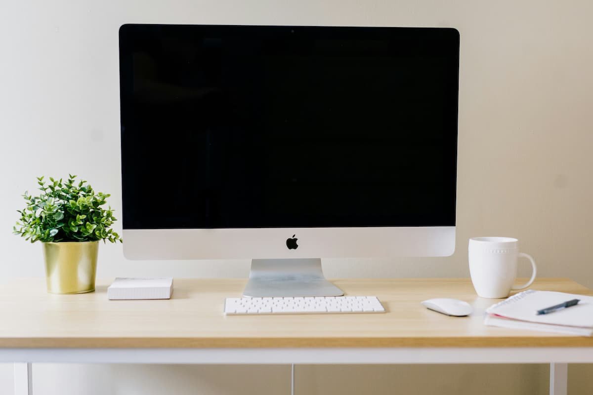 A home office desk with an iMac